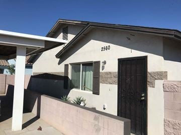 Phoenix apartment for rent - the front of a white house with a black door