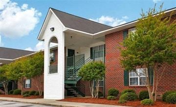 Rocky Mount apartment for rent - a red brick apartment building with a porch and stairs