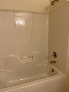 Youngsville apartment for rent - A white bathtub with a silver faucet and a shower head.