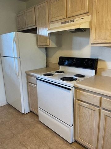 Youngsville apartment for rent - A white stove and refrigerator in a kitchen.