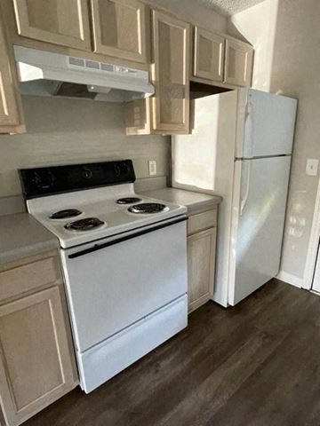 Youngsville apartment for rent - A white stove and refrigerator in a kitchen.