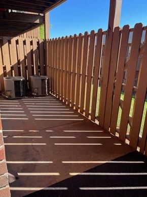 Youngsville apartment for rent - A wooden fence is in front of a building.