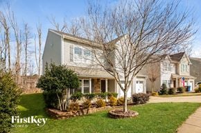 Mooresville house for rent - A house with a grey roof and a tree in front of it.