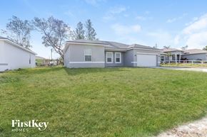 Poinciana house for rent - A house with a lawn in front of it is for sale.