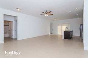 Poinciana house for rent - A spacious room with a ceiling fan and a television.
