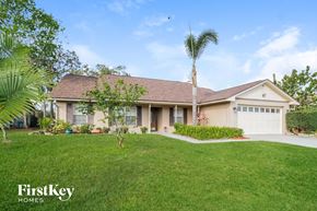 Casselberry house for rent - A house with a brown roof and a white garage door is for sale.