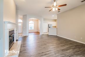 Orange Park house for rent - A spacious living room with a fireplace and hardwood floors.