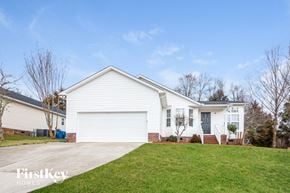 Concord house for rent - A white house with a garage door is for sale.