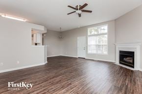 Concord house for rent - A spacious living room with a fireplace and wood flooring.