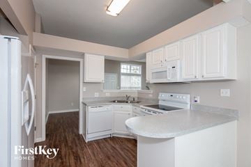 Concord house for rent - A kitchen with white cabinets and appliances in a house by FirstKey Homes.