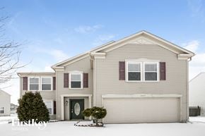 Indianapolis house for rent - a beige house with snow on the ground