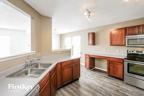 Indianapolis house for rent - a kitchen with wooden cabinets and stainless steel appliances