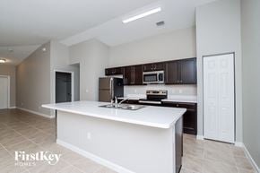 Palm Bay house for rent - a kitchen with a white counter top and a sink