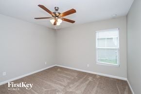Palm Bay house for rent - a bedroom with a ceiling fan and a window