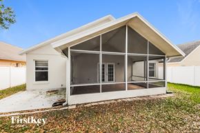 Orlando house for rent - A house with a white exterior and a large glass wall.