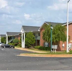 Youngsville apartment for rent - A parking lot in front of a building with a car parked.