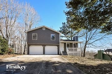 Flowery Branch house for rent - a gray house with a garage and a driveway