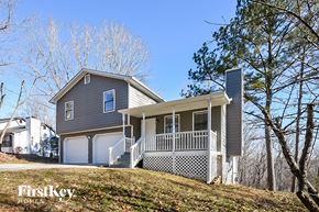 Flowery Branch house for rent - a gray house with a porch on a hill
