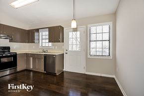 Flowery Branch house for rent - an empty kitchen with stainless steel appliances and a window