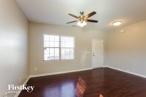 Charlotte house for rent - A room with a ceiling fan and wooden floors.