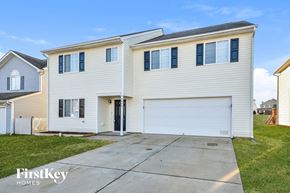 Mcleansville house for rent - a white house with white siding and a white garage door