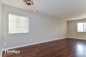 Mcleansville house for rent - the living room with wood floors and a large window