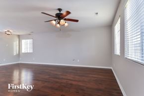 Mcleansville house for rent - the living room with wood floors and a ceiling fan