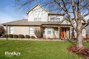 Carmel house for rent - a white brick house with a tree in the front yard