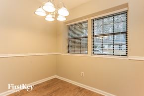 Lithonia house for rent - a bedroom with three windows and a wooden floor