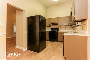 Lithonia house for rent - a kitchen with stainless steel appliances and a black refrigerator
