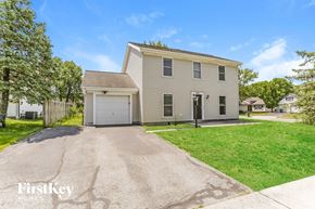Hilliard house for rent - a beige house with a garage and a driveway