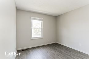 Hilliard house for rent - a bedroom with white walls and wood floors and a window