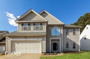 Charlotte house for rent - a gray house with a white garage door