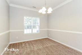 Charlotte house for rent - a bedroom with a carpeted floor and a window