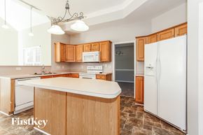 Charlotte house for rent - a kitchen with wooden cabinets and a white counter top
