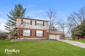 West Chester house for rent - a large brick house with a lawn in front of it