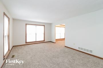 West Chester house for rent - a living room with carpet and two windows