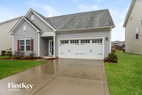 Concord house for rent - a large white house with a white garage door