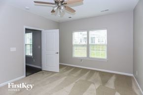 Concord house for rent - a living room with a ceiling fan and two windows