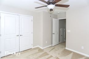 Concord house for rent - a bedroom with two closet doors and a ceiling fan