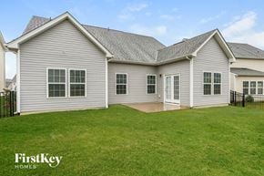Concord house for rent - the backyard of a home with a patio and green grass