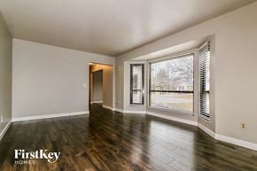 Saint Peters house for rent - an empty living room with wood floors and a large window