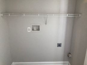 Youngsville apartment for rent - A white wall with a shelf and a picture frame.