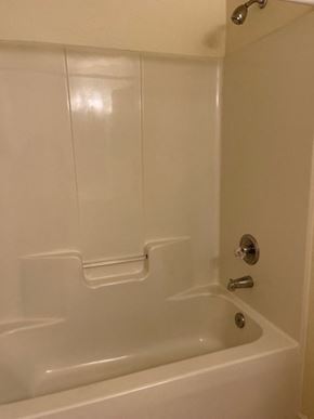 Youngsville apartment for rent - A white bathtub with a silver faucet and a shower head.