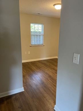 Youngsville apartment for rent - A room with wooden floors and a window with blinds.