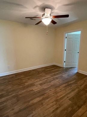 Youngsville apartment for rent - A room with a ceiling fan and wooden flooring.