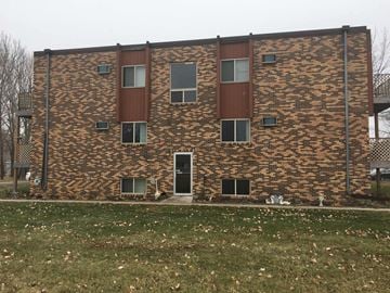 Thief River Falls apartment for rent - A brick building with a brown door and windows.