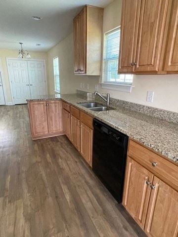 Youngsville apartment for rent - A kitchen with wooden cabinets and a black dishwasher.