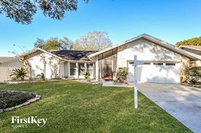 Valrico house for rent - a white house with a yard and a driveway and a white mailbox