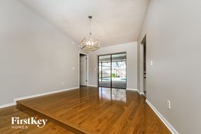 Valrico house for rent - a spacious living room with hardwood flooring and a door to the pool
